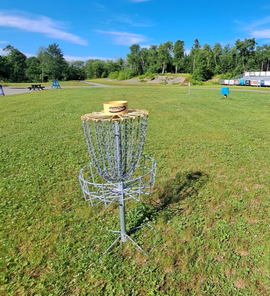 A basket in the open field near the lodge and parking area